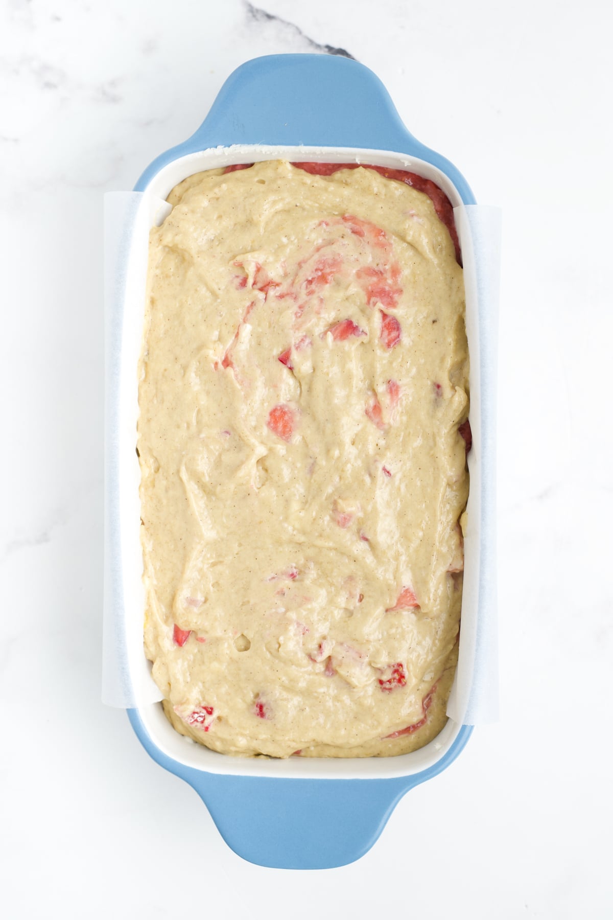The batter transferred to a prepared loaf pan.