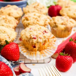Strawberry rhubarb muffins on a cooling rack.