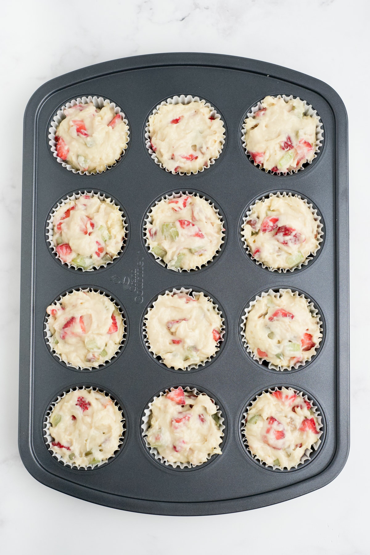 Muffin batter added to the pan. 