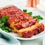 Chicken meatloaf sliced on a white platter.