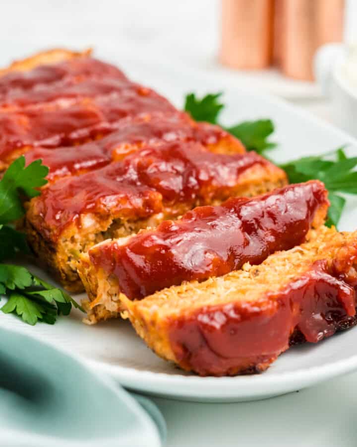 Chicken meatloaf sliced on a white platter.