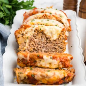 A platter with slices of meatloaf on it.