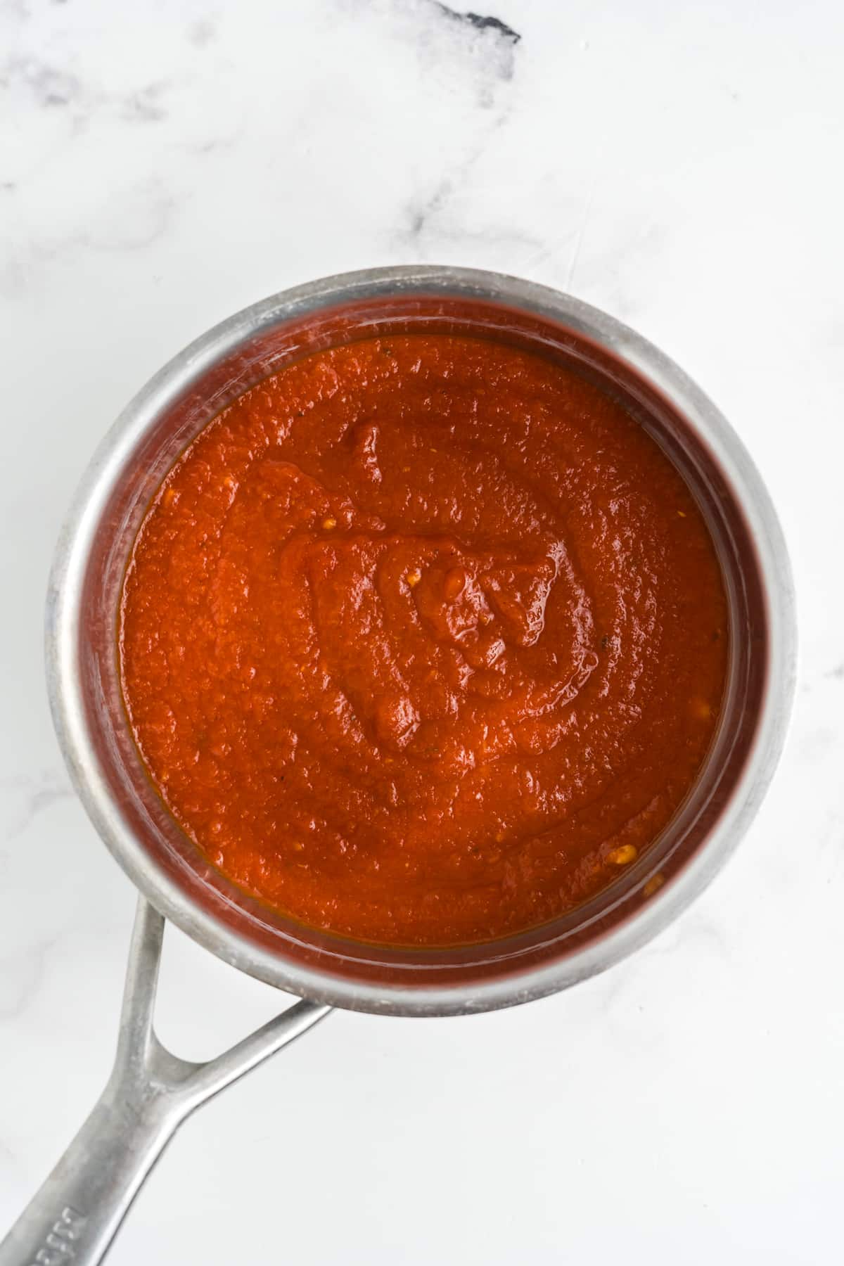 Marinara sauce in a saucepan.