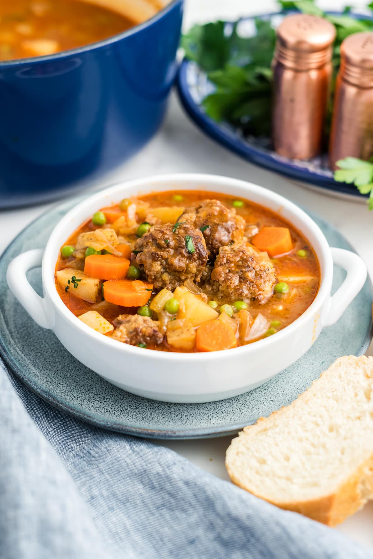 Meatball stew in a white bowl.