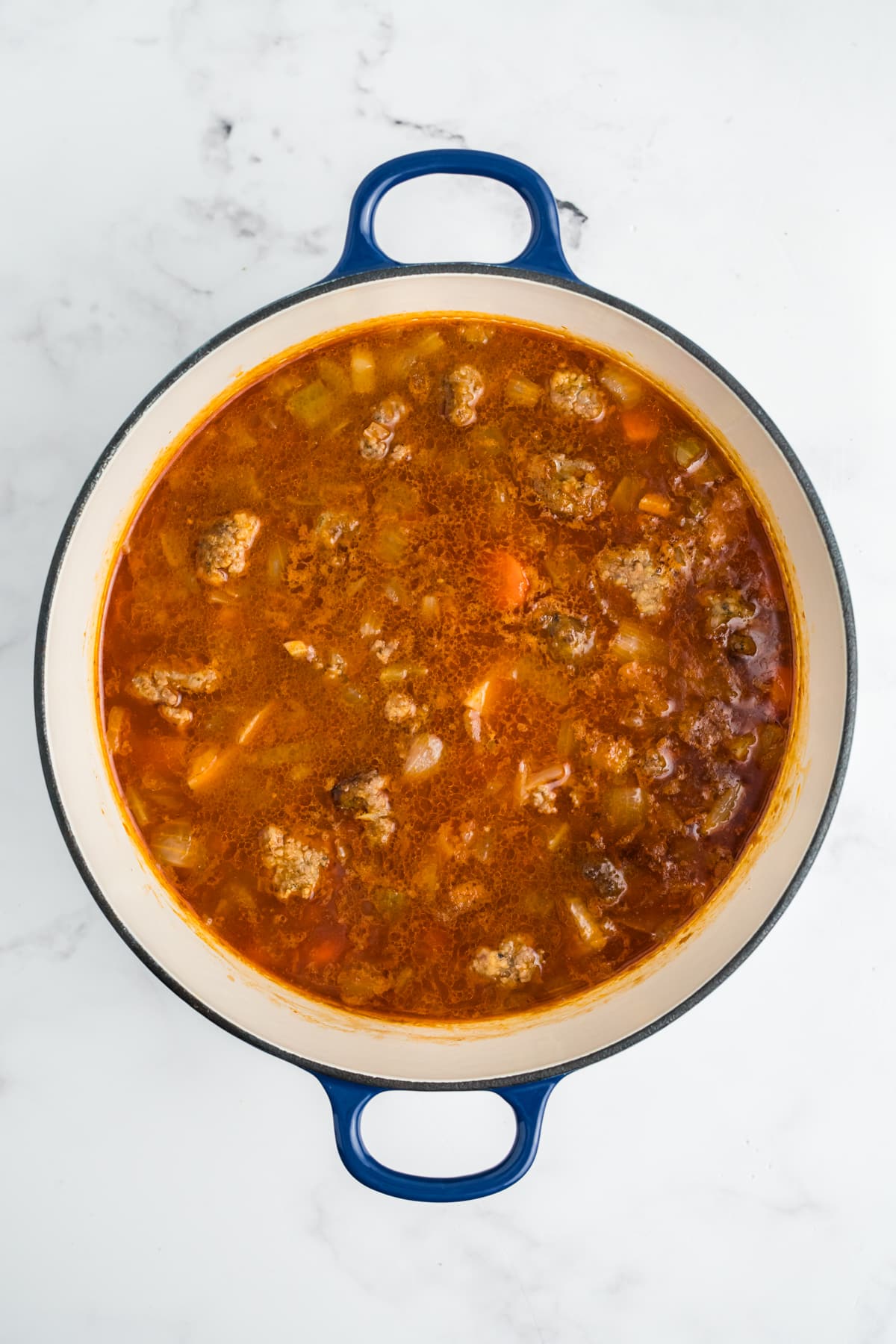 The meatballs added back to the pot.