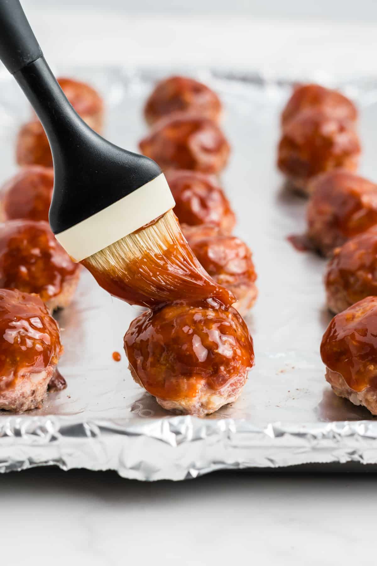 The glaze brushed over top of the meatballs.