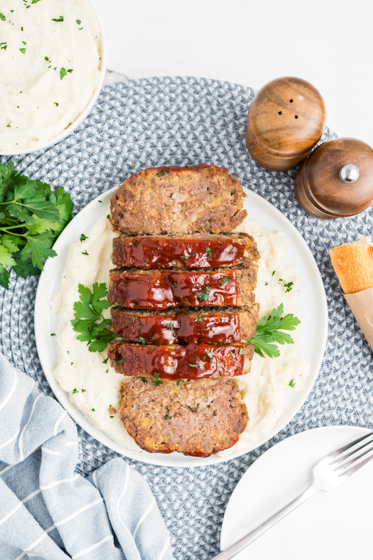 Sliced up meatloaf on a plate.