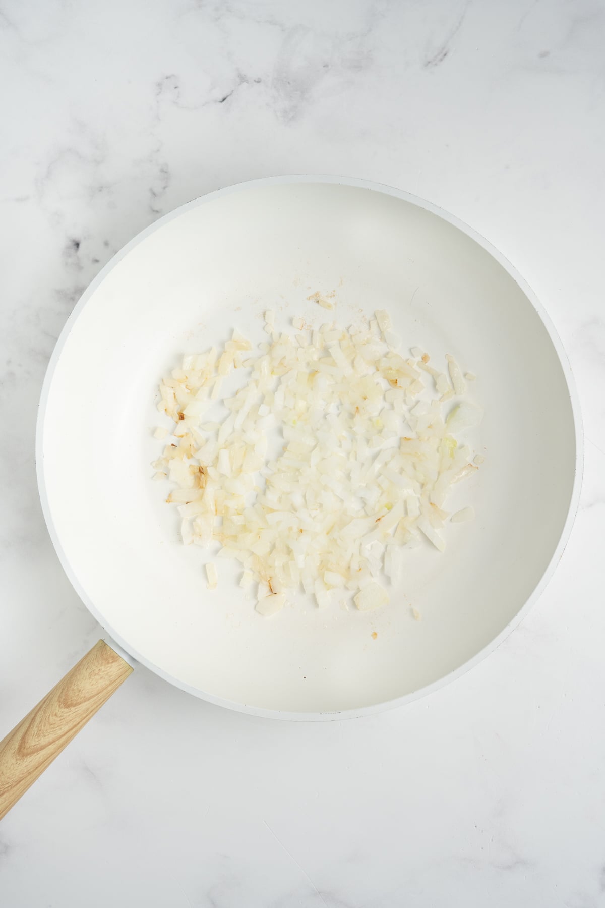 Onions sauteing in a pan.