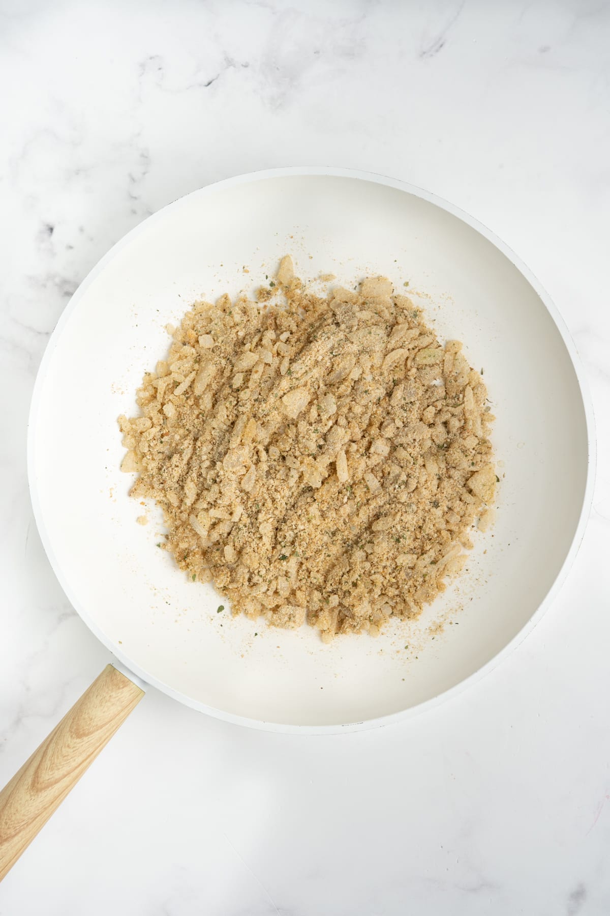 Breadcrumbs added into the skillet.