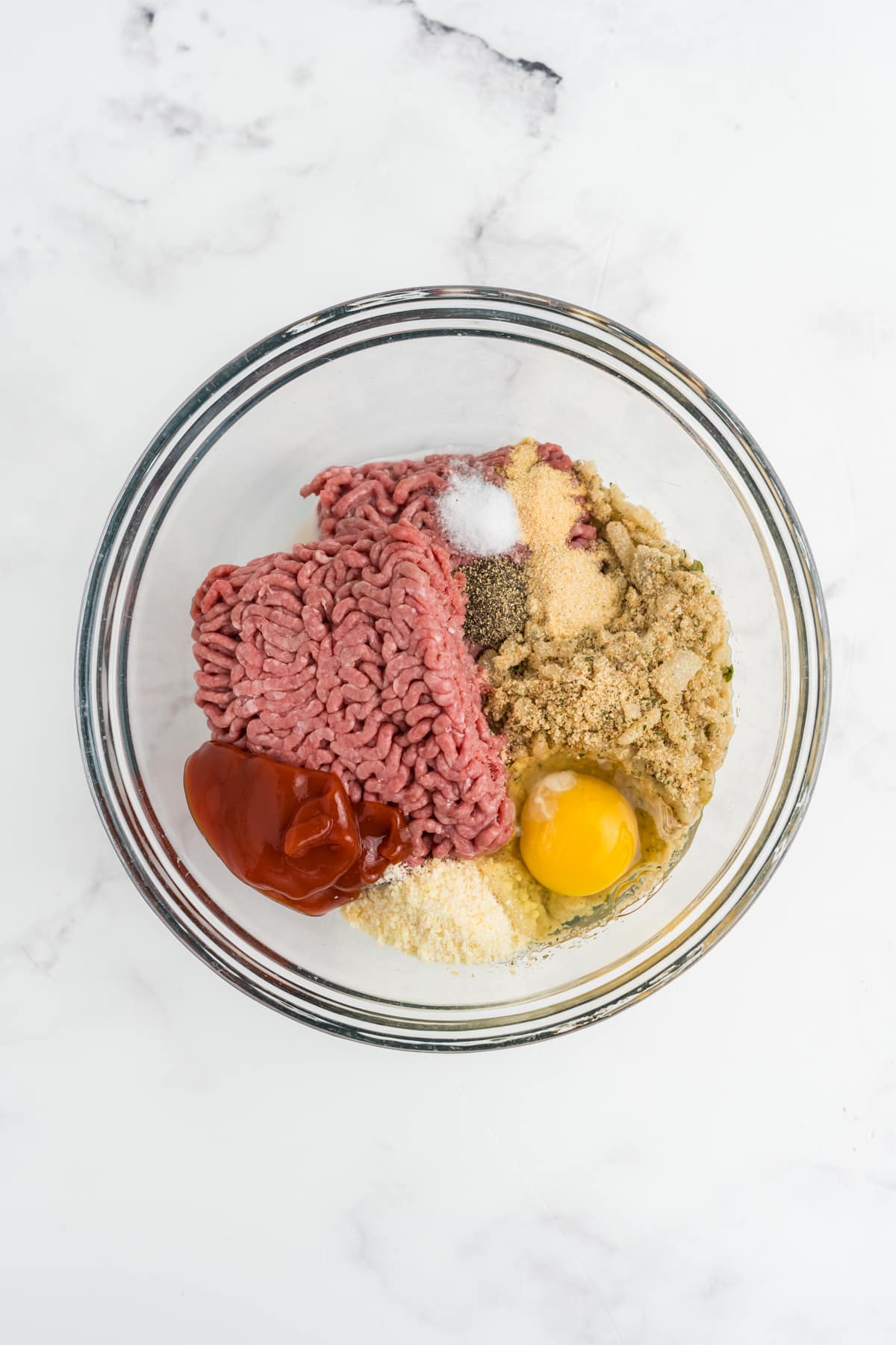 The meatloaf ingredients into the bowl.