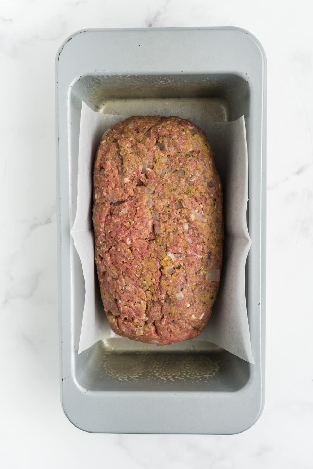 The meat mixture in a loaf pan.