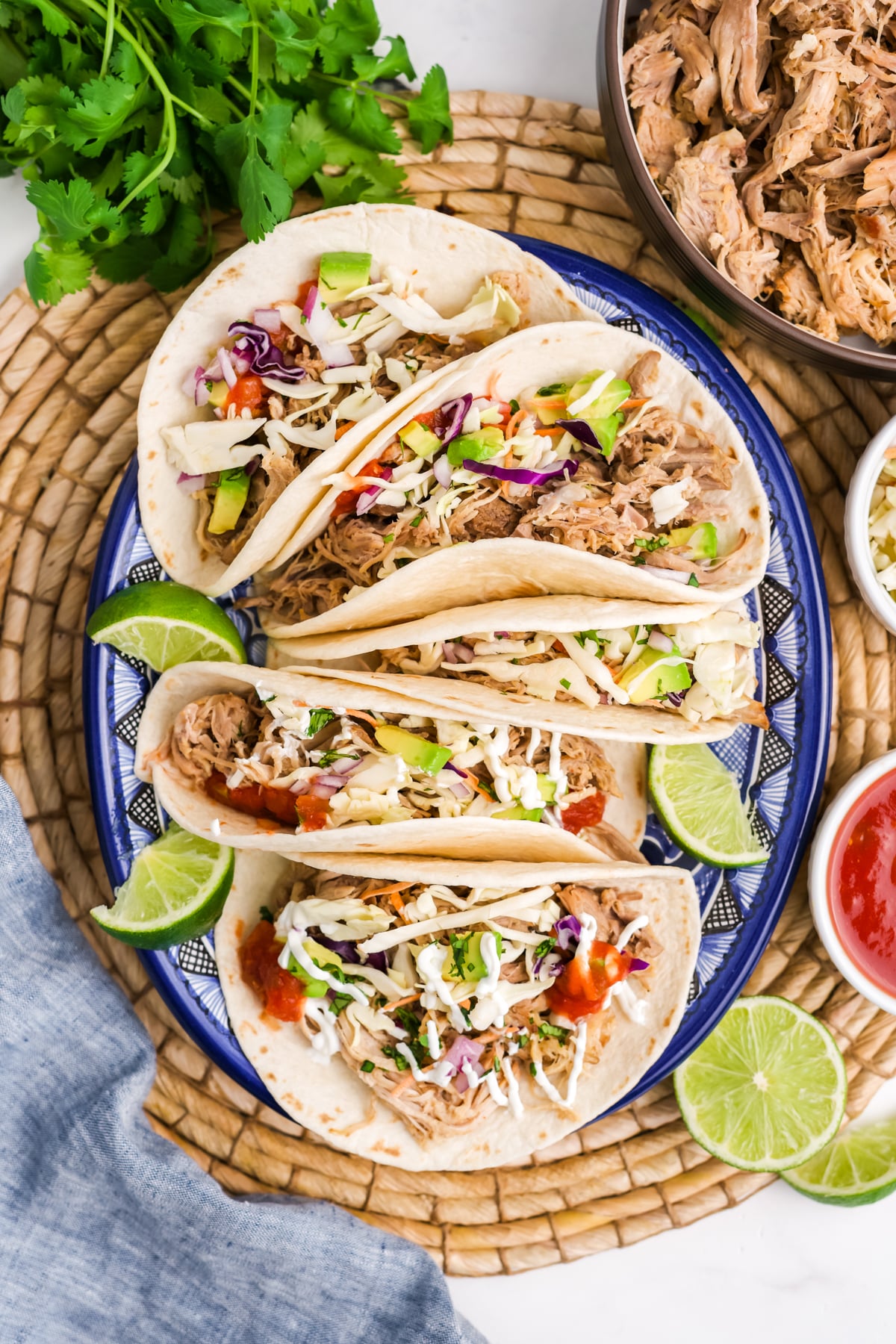 Pulled pork tacos with lime garnish on the side.
