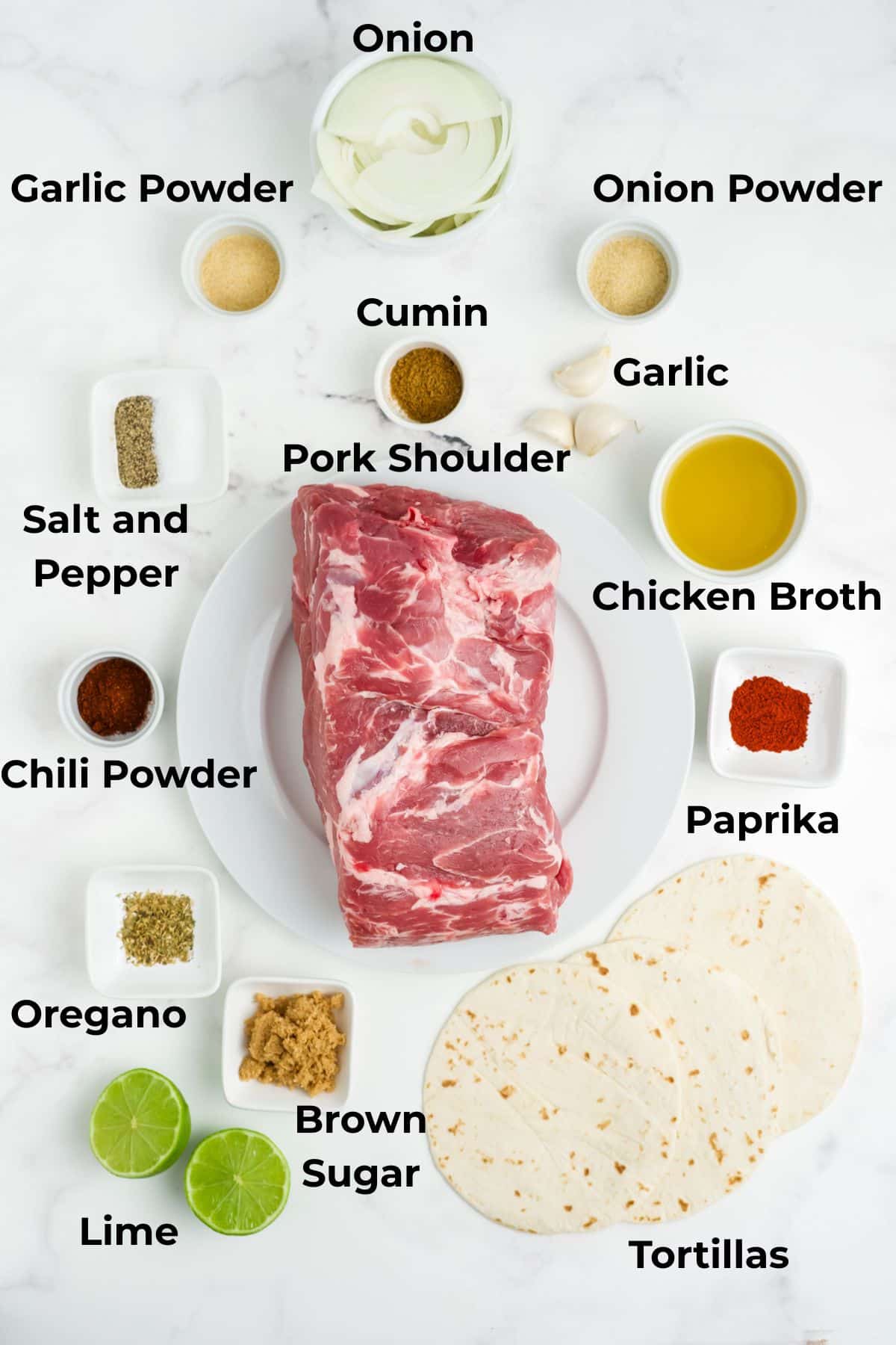 Ingredients to make pulled pork tacos in bowls on a table.