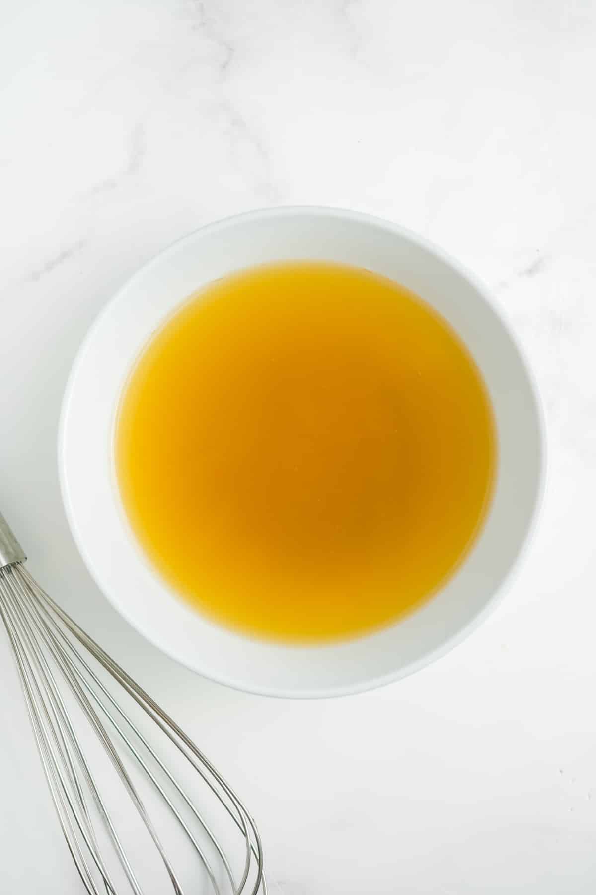 Chicken broth, lime juice, and brown sugar in a bowl.