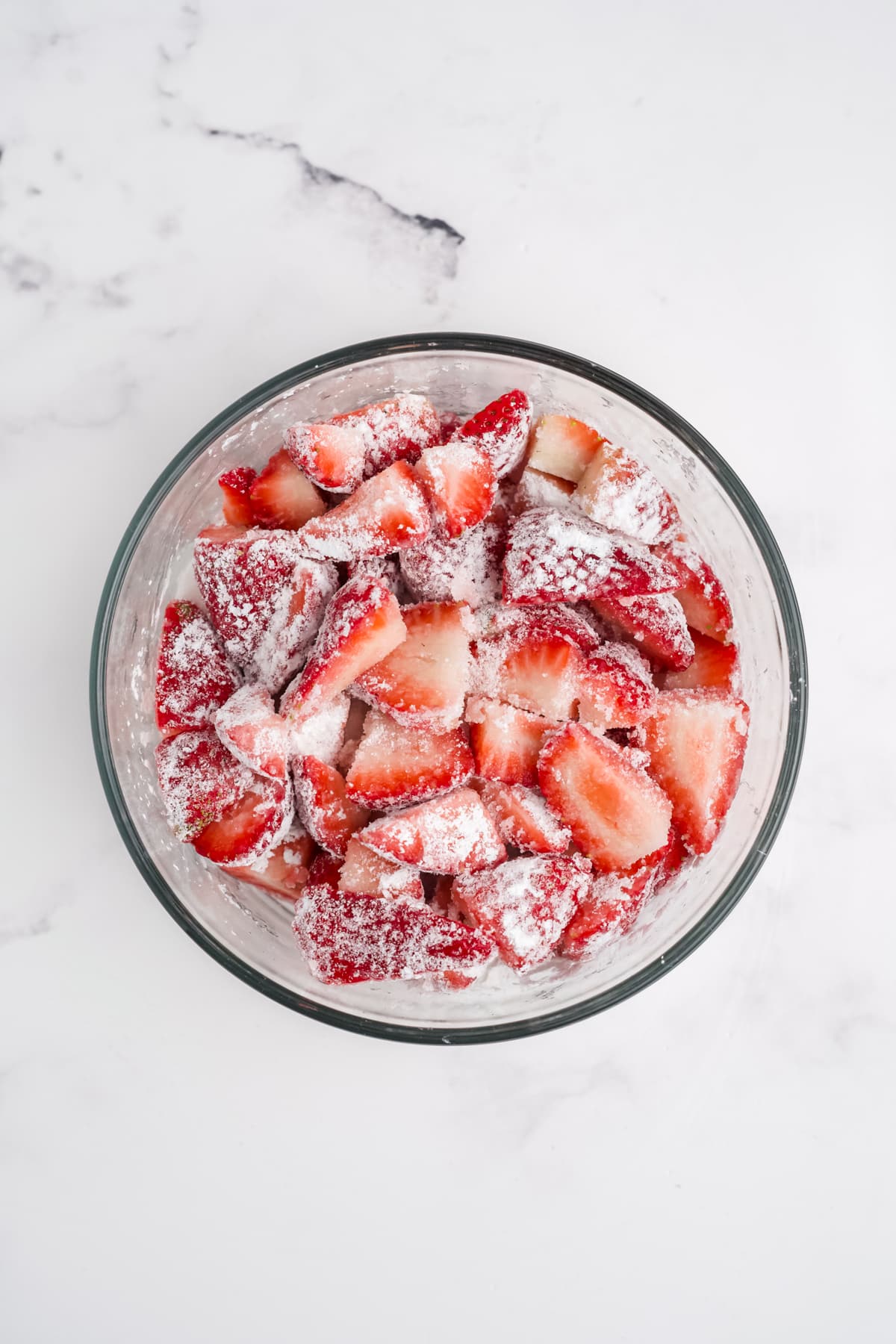 Strawberries, sugar, and cornstarch in a bowl