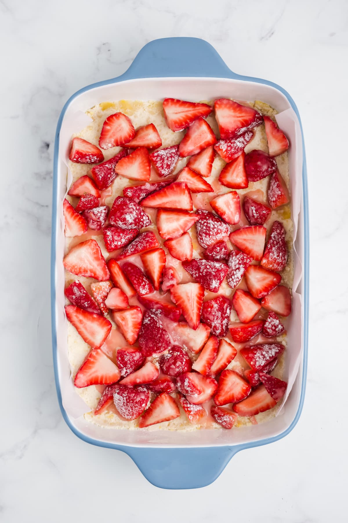 Strawberries layered over the crust layer.