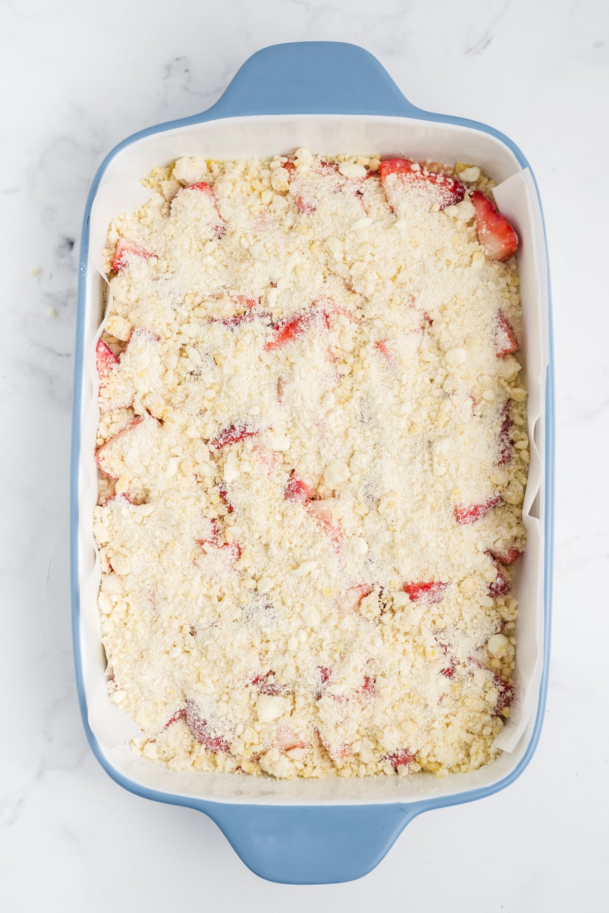 The crumbled topping layered over the strawberries.