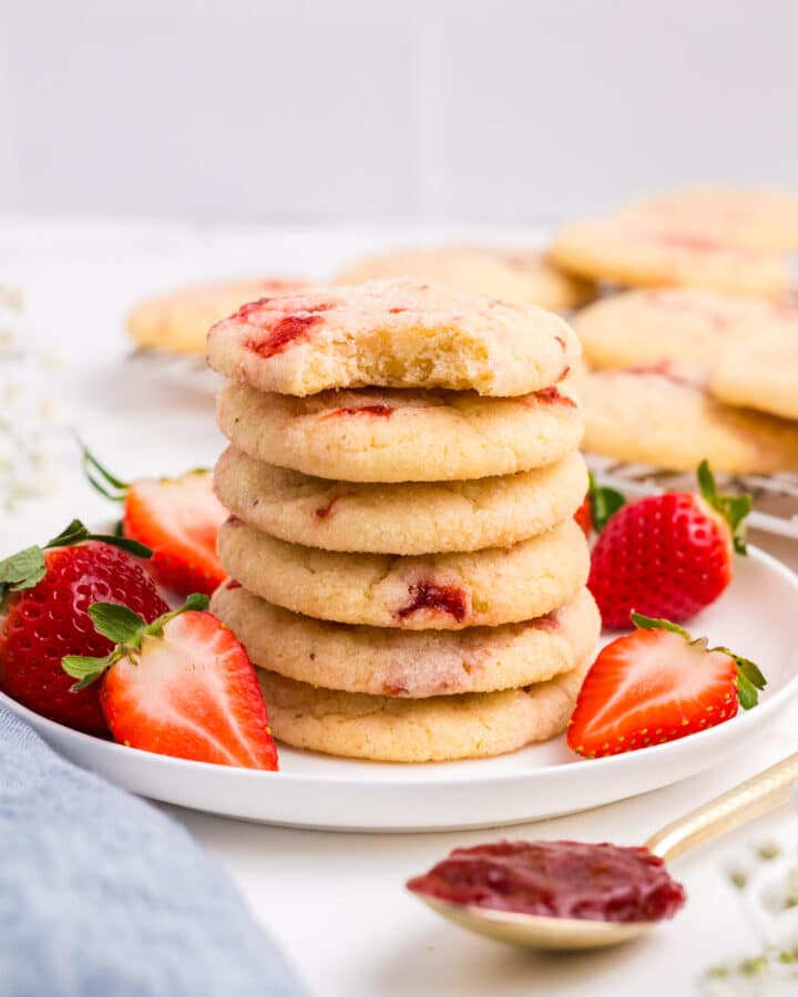 A stack of strawberry sugar cookies on a plate.
