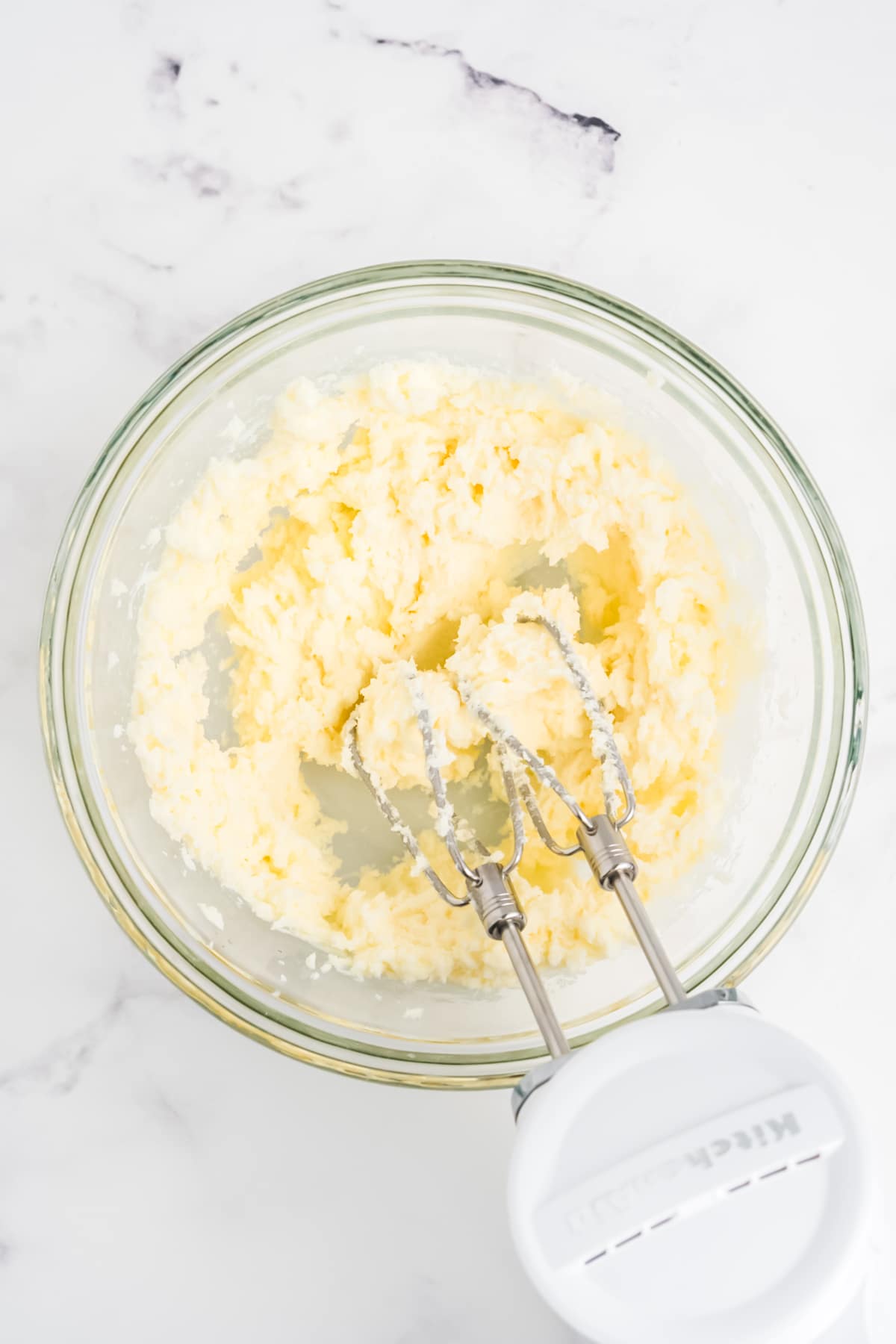 The butter and sugar being mixed in a bowl.
