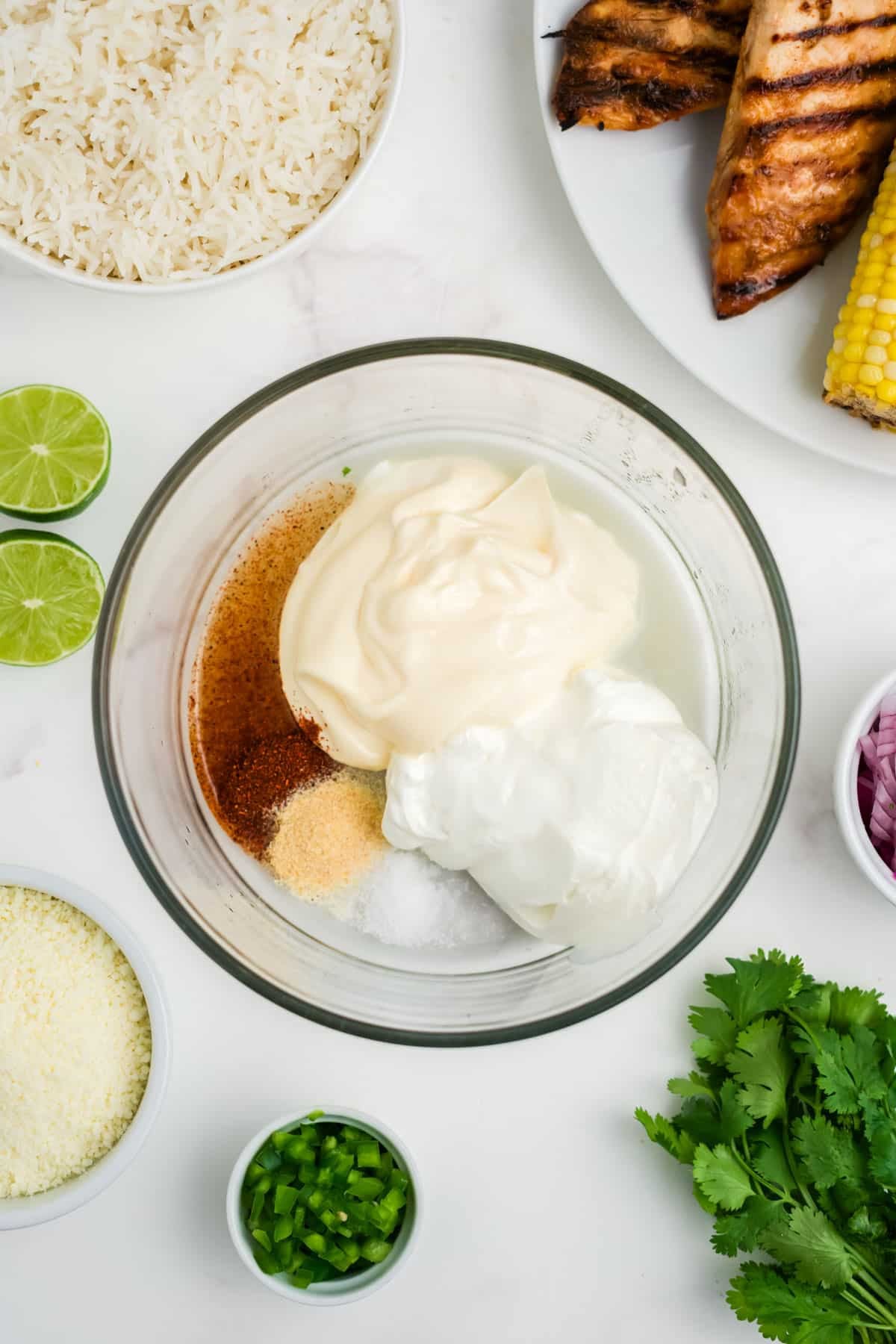 Ingredients in a bowl for elote street corn chicken and rice bowls dressing.