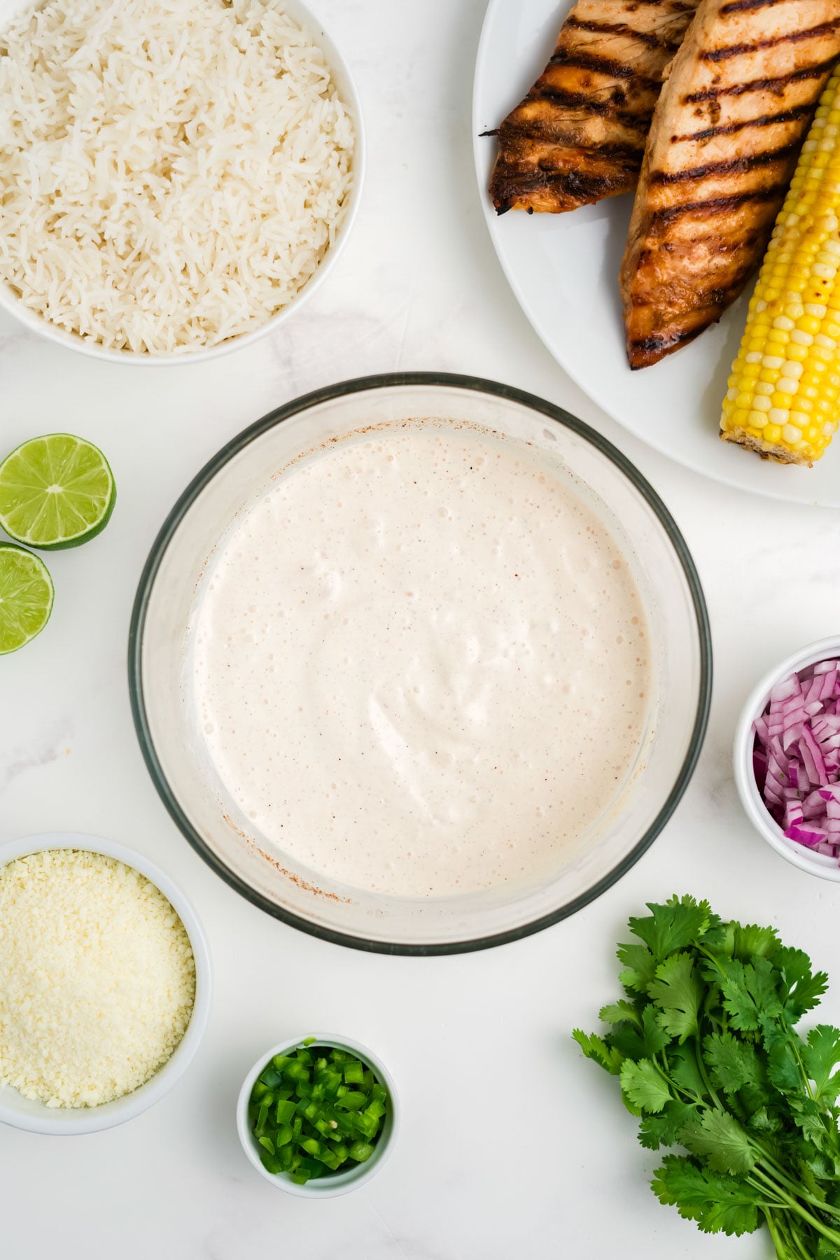 Dressing for chicken and rice bowls in a bowl.